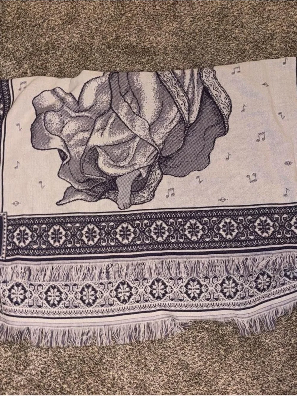 Purple and white tapestry blanket with music notes and angel playing harp